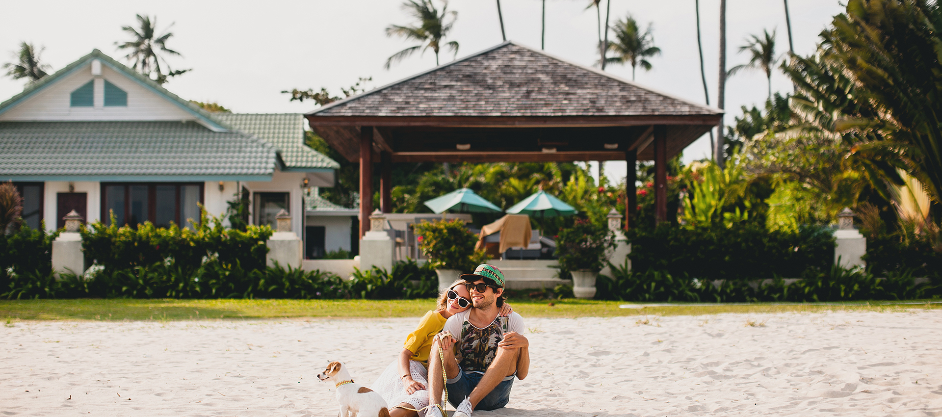 Couple dog tropical beach vacation
